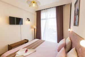 um quarto de hotel com uma cama e uma janela em Hasambarana Apparthotel em Antananarivo