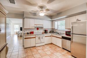 a kitchen with white cabinets and a refrigerator at Manatee River House in Bradenton