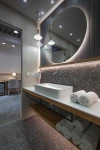 a bathroom with a sink and a mirror at Pensjonat Tatry in Kościelisko