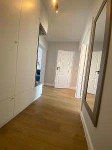 an empty room with two doors and a mirror at Apartament Mazovia Prestige in Płock