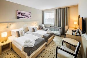 Postel nebo postele na pokoji v ubytování Aquapalace Hotel Prague