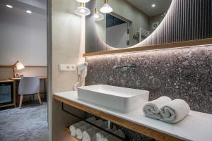 a bathroom with a sink and a mirror at Pensjonat Tatry in Kościelisko