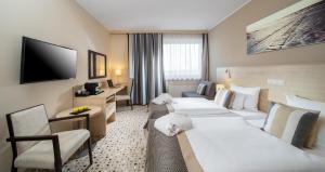 Postel nebo postele na pokoji v ubytování Aquapalace Hotel Prague