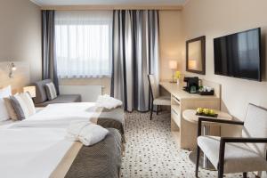 Postel nebo postele na pokoji v ubytování Aquapalace Hotel Prague