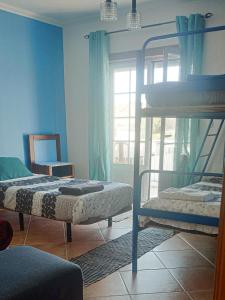 two bunk beds in a room with a window at Cloud to Chill Surfhouse Baleal in Ferrel