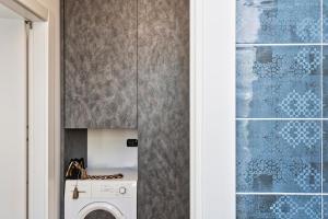 a laundry room with a washer and dryer at Le Chicche del Porto - Allure in Genoa