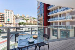 a balcony with a table and chairs on a balcony at Le Chicche del Porto - Allure in Genoa