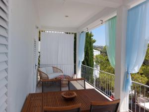 a balcony with a table and chairs on a balcony at Mar Vista in Primošten