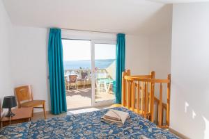 a bedroom with a bed and a view of the ocean at Westhaven Bay in Costa Del Silencio