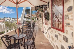 a patio with tables and chairs on a balcony at Villa Hoa Da in Da Lat