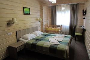 a bedroom with a bed in a wooden room at Шале На бе́резі in Kvasy