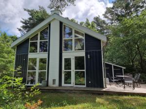 a house with large windows and a patio at Haus Sandra in Baabe