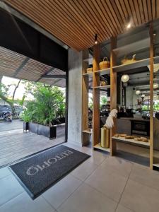 an open kitchen with a large glass door and a rug at Eutopiq Hotel in Medellín