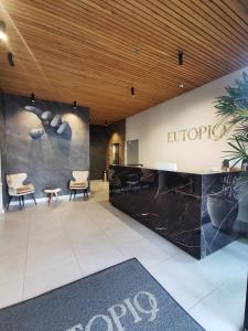 a lobby of an office building with a reception desk at Eutopiq Hotel in Medellín