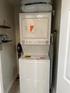 a white refrigerator freezer sitting in a kitchen at Uber Close to Ohio City, Cleveland (Lower) in Cleveland