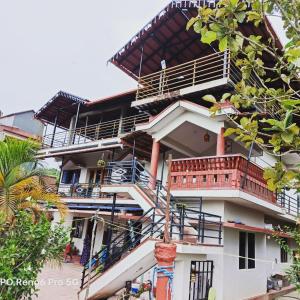 a building with balconies on the side of it at Coorg girinivas homestay 102 in Madikeri
