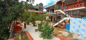 a courtyard with potted plants in front of a building at Coorg girinivas homestay 102 in Madikeri