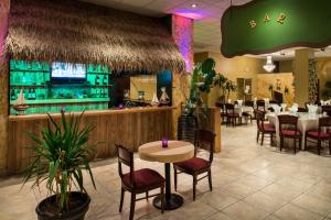 a restaurant with a table and chairs and a bar at Grand Hotel Ocean City Oceanfront in Ocean City