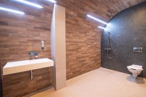 a bathroom with a sink and a shower and a toilet at Hotel Messa in Władysławowo