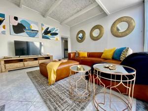 a living room with a couch and two tables at Sea View Penthouse in Ballito