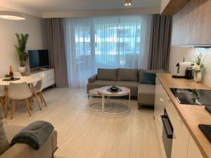 a living room with a couch and a table at Lake View Sea Apartment Rogowo Pearl in Rogowo