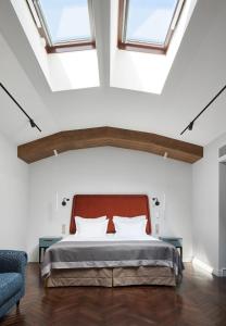 a bedroom with a large bed with skylights at Helvetia Hotel in Saint Petersburg