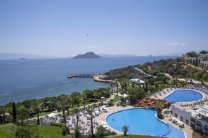 an aerial view of a resort with a pool and the ocean at Yasmin Bodrum Resort in Gümüşlük +79 photos