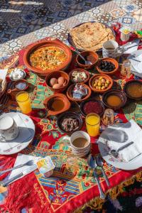 a table full of food and drinks on a table at Amazigh Family Riad in Imlil