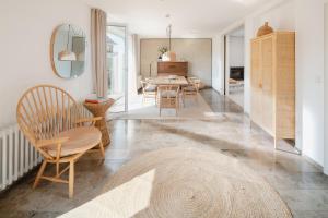 a living room with a table and chairs at Haus Janus 1 - Wohnung 1 in Norderney