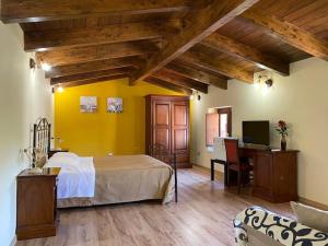 a bedroom with a bed and a desk with a computer at Borgo Patierno in Conca della Campania