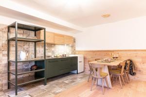 une cuisine avec une table et un meuble vert dans l'établissement 13 Comuni Ristorante E Albergo, à Velo Veronese
