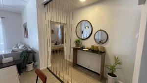 a bathroom with a shower and a vanity and mirror at Le coquillage in Trou aux Biches +10 photos