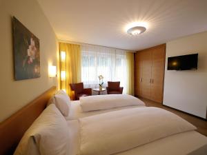 Hotel Restaurant Eichberg tesisinde bir odada yatak veya yataklar