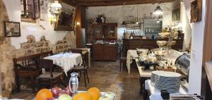 a restaurant with tables and chairs and a kitchen at B&B Palace Basilico 1580. in Rovinj