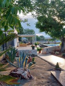 a garden with a swimming pool and a house at Dimora Carucci in Noci