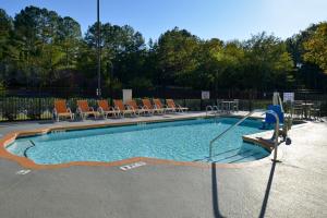 a large swimming pool with chairs and a table at Best Western Plus Clemson Hotel & Conference Center in Clemson