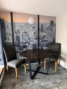 a dining room with a table and two chairs at Schillers Terrassen Fewo in Cottbus