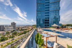 罗安达InterContinental Luanda Miramar by IHG的从带游泳池的大楼的阳台上可欣赏到风景