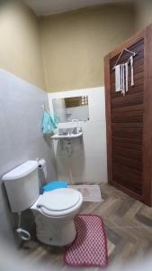 a bathroom with a toilet and a sink at Pousada Recanto da Mada Alter in Alter do Chao