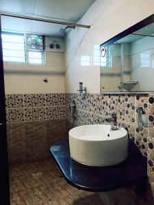 a bathroom with a sink and a mirror at HOTEL SRIRAMA EMPIRE in Hyderabad