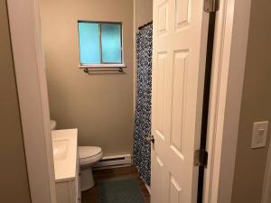 a bathroom with a toilet and a window at Carter #1 Two bedroom unit near Xavier Downtown in Cincinnati