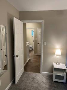 a hallway with a bathroom with a toilet and a sink at Carter #1 Two bedroom unit near Xavier Downtown in Cincinnati