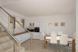 a dining room with a table and white cabinets at Sunset Sea View Villa 8 in Afionas