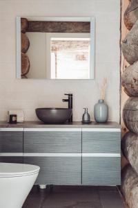 een badkamer met een wastafel en een spiegel bij Hideout Villas - Fort Aurora in Levi