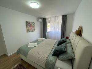a bedroom with a bed and a couch and a window at Amigi in Sarajevo