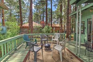 a porch with chairs and a grill and trees at 2 Mi to Rainbow Lake Woodsy Retreat with Deck! in Pinetop-Lakeside