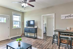a living room with a television and a table at Bowling Green Apartment in the Heart of Town! in Bowling Green