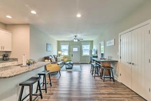 a kitchen and living room with a counter and chairs at Bowling Green Apartment in the Heart of Town! in Bowling Green
