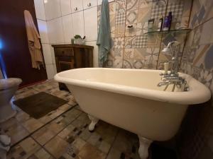 a bathroom with a bath tub and a sink at Casa Abaeté Chapada Diamantina in Mucugê +30 photos