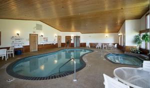 a large swimming pool in a room with tables and chairs at Country Inn Two Harbors in Two Harbors